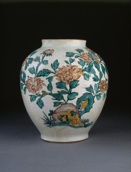 Jar with flowering plants and butterfliesside