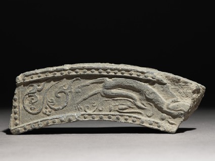Fragment of a roof-tile with running dragonfront