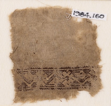 Textile fragment with stylized vine and flowersfront