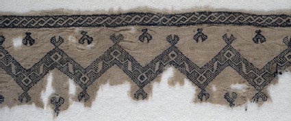 Textile fragment with chevrons and interlacing scrollsfront