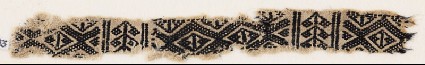 Textile fragment with linked-diamond shapes and stylized plantsfront