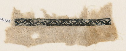 Textile fragment with vine and stylized leaf or tendrilfront