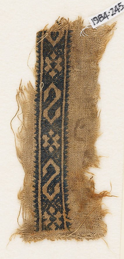 Textile fragment with S-shapes and rosettesfront