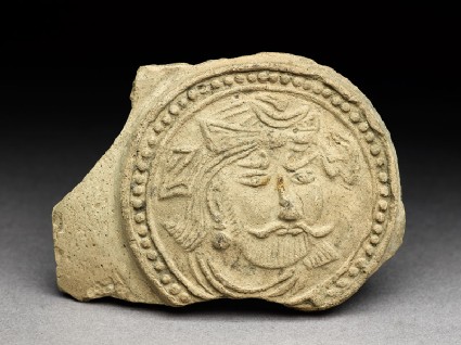 Medallion from a pot depicting a bearded figure, possibly a bodhisattvafront