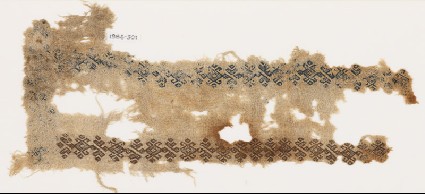 Textile fragment with linked hooks and stylized leavesfront