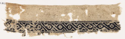 Textile fragment with scroll of linked S-shapes and rosettesfront