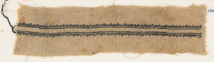 Textile fragment with triangles and stylized flowersfront