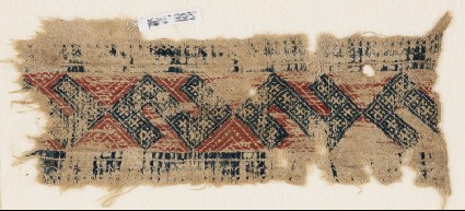 Textile fragment with linked S-shapes and crossesfront