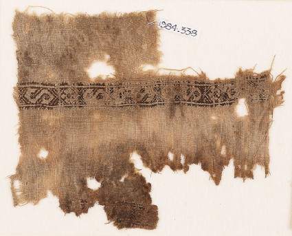 Textile fragment with S-shapes, rosettes, and chevronsfront
