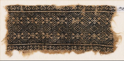 Textile fragment with linked diamond-shapes, rosettes, and possibly palmettesfront