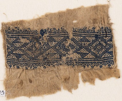 Textile fragment with linked diamond-shapes, triangles, and flowersfront
