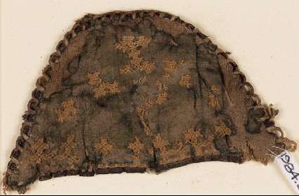 Textile fragment from a slipper front with linked crossesfront