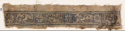Textile fragment with eight-pointed stars and inscriptionfront