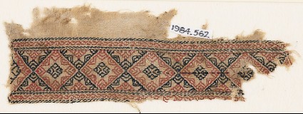 Textile fragment with linked diamond-shapes containing eight-pointed starsfront