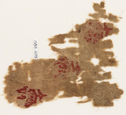 Textile fragment with three circles containing crescentsfront