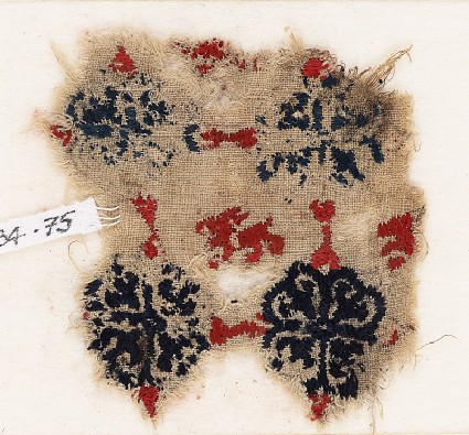 Textile fragment with lion and grid of quatrefoil flowersfront