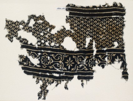 Textile fragment with linked chevrons and flowers, possibly from a garmentfront