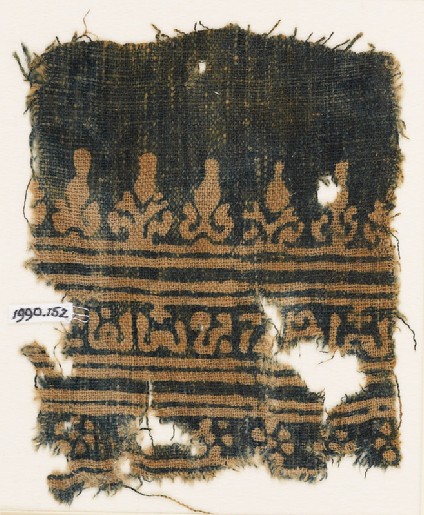 Textile fragment with inscription, rosettes, and stylized trees and palmettesfront