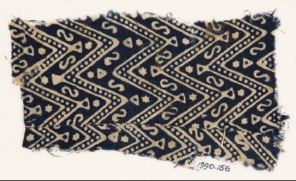 Textile fragment with large chevrons, dots, S-shapes, and starsfront