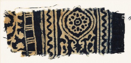 Textile fragment with medallion, and a vine with leaves and flowersfront