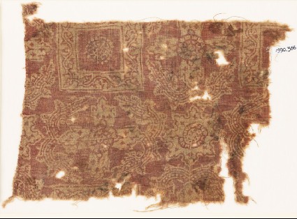 Textile fragment with ornate squares, flowers, and crossesfront
