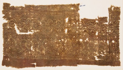 Textile fragment with stylized plants linked to form medallionsfront