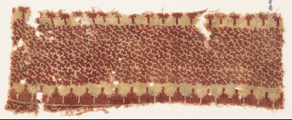 Textile fragment with stylized tendrils and crenellationsfront