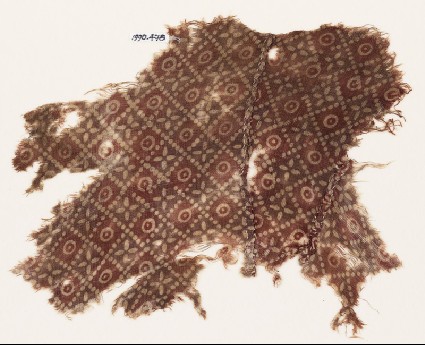 Textile fragment with grid of dots, circles, and rosettes, probably from a garmentfront