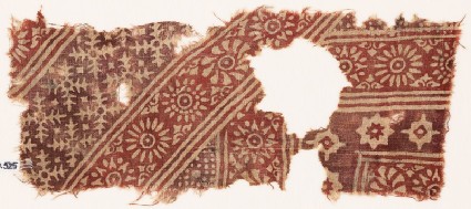 Textile fragment with rosettes, serrated crosses, stars, and dotsfront