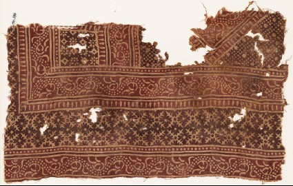Textile fragment with bands of vines and serrated crossesfront