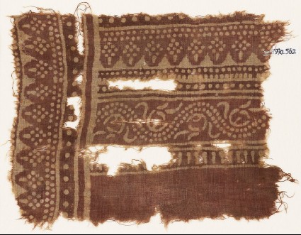 Textile fragment with dotted vine and rhombic shapesfront
