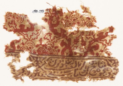 Textile fragment with Persian script and floral shapesfront