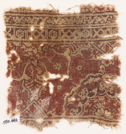 Textile fragment with ornate floral design and a large half-medallionfront