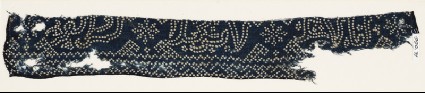 Textile fragment with geometric patterns, stars, and possibly script made of dotsfront