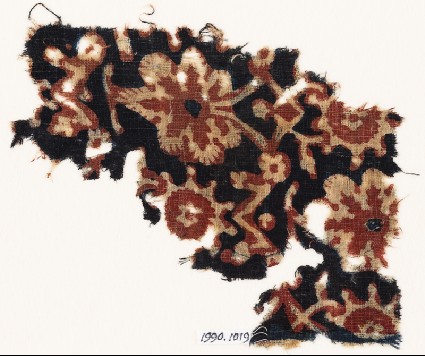Textile fragment with vine leaves, flowers, and tendrilsfront