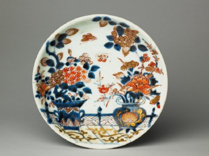 Saucer with flowers on a terracetop