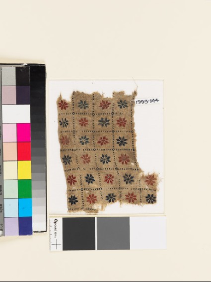 Textile fragment with grid of rosettesfront