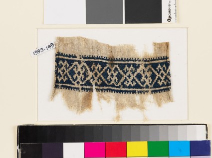 Textile fragment with double diamond-shapes and crossesfront