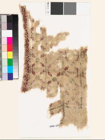 Textile fragment with grid of squares, rosettes, and leavesfront