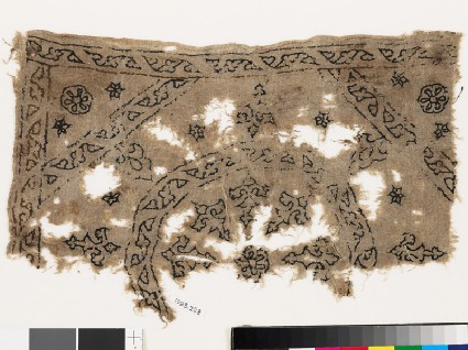 Textile fragment with remains of a roundel, octagon, square, and plant shapesfront