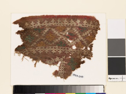 Textile fragment with diamond-shapes and crossesfront