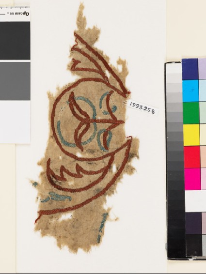 Textile fragment with plant, circle, and leavesfront