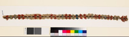 Textile fragment with pairs of stylized budsfront