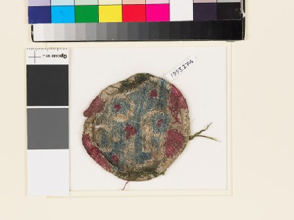 Roundel textile fragment with elaborate lobed crossfront