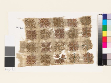 Textile fragment with stylized flower-headsfront
