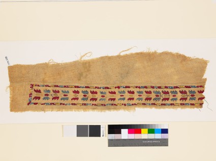 Textile fragment with band of floral shapesfront