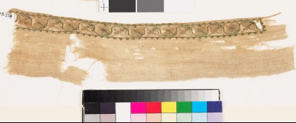 Textile fragment with scrolling stem and stylized flower-headsfront
