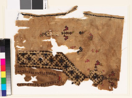Textile fragment from the neck of a tunic with a V-shape, birds, and plantsfront