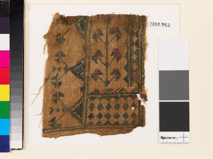 Textile fragment with stylized flowers, diamond-shapes, and trianglesfront