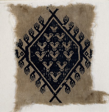 Textile fragment with hands and diamond-shaped medallionfront